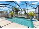 Sparkling pool with screen enclosure, palms, and a fountain with basketball hoop at 14363 59Th E Cir, Lakewood Ranch, FL 34211
