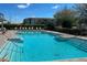 Inviting community pool with lounge chairs and a bright blue sky backdrop at 14363 59Th E Cir, Lakewood Ranch, FL 34211