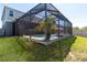 Screened pool area, showcasing the pool, patio, and lush green lawn at 14363 59Th E Cir, Lakewood Ranch, FL 34211