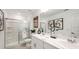 Bright bathroom featuring a glass shower and a double sink vanity with modern fixtures at 15149 Cuzcorro Ct, Nokomis, FL 34275