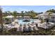 Community pool featuring lounge seating, umbrellas, covered gazebos and palm trees, providing a resort-like experience at 15177 Cuzcorro Ct, Nokomis, FL 34275
