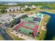 Overhead view of a community with tennis courts, swimming pool, parking, and lakeside views at 175 Kings Hwy # B5, Punta Gorda, FL 33983