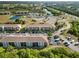 Aerial shot of condos with parking, landscaping, pond, pool, and surrounding greenery at 175 Kings Hwy # B5, Punta Gorda, FL 33983