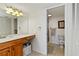 Well-lit bathroom featuring a wooden vanity with double sinks and a separate toilet and shower area at 175 Kings Hwy # B5, Punta Gorda, FL 33983