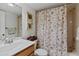 Cozy bathroom with vanity, toilet, and a shower-tub combo with a seashell-themed curtain at 175 Kings Hwy # B5, Punta Gorda, FL 33983