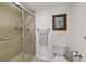 Clean bathroom with a shower, toilet, towel bar, and grab bar at 175 Kings Hwy # B5, Punta Gorda, FL 33983