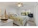 Bright bedroom featuring a ceiling fan, large window, and nautical accents for a cozy living space at 175 Kings Hwy # B5, Punta Gorda, FL 33983