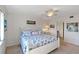 Cozy bedroom features a beach-themed comforter, ceiling fan, and bright white walls at 175 Kings Hwy # B5, Punta Gorda, FL 33983