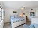 Bright bedroom featuring a beach-themed comforter, ceiling fan, and ensuite bathroom at 175 Kings Hwy # B5, Punta Gorda, FL 33983
