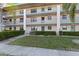 Three-story condo building has manicured landscaping, walkways, and private balconies at 175 Kings Hwy # B5, Punta Gorda, FL 33983