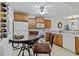 Compact kitchen featuring wooden cabinets, wine rack, breakfast bar, and ceiling fan at 175 Kings Hwy # B5, Punta Gorda, FL 33983