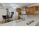 Functional kitchen featuring wooden cabinets, white countertops, and wine storage at 175 Kings Hwy # B5, Punta Gorda, FL 33983