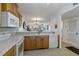 Kitchen with white appliances and view of the living room and balcony at 175 Kings Hwy # B5, Punta Gorda, FL 33983