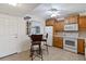Bright kitchen featuring white appliances, wooden cabinets, wine rack, and ceiling fan at 175 Kings Hwy # B5, Punta Gorda, FL 33983