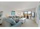Comfortable living room with large sofa, coffee table, and balcony access at 175 Kings Hwy # B5, Punta Gorda, FL 33983