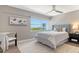 Comfortable bedroom with a plush bed, serene decor, and a scenic view from the large window at 1750 Benjamin Franklin Dr # 6F, Sarasota, FL 34236