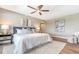 Bright bedroom with ceiling fan, hardwood floors, a king bed, neutral color palette, and stylish decor at 1750 Benjamin Franklin Dr # 6F, Sarasota, FL 34236