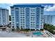 Striking exterior view of a high-rise condominium with a pool and beach access at 1750 Benjamin Franklin Dr # 6F, Sarasota, FL 34236