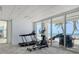 Well-equipped fitness center featuring cardio equipment, large windows, and a view of the beach at 1750 Benjamin Franklin Dr # 6F, Sarasota, FL 34236