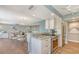 Updated kitchen flows into living room, boasting stainless steel appliances and stone countertops for easy living at 1750 Benjamin Franklin Dr # 6F, Sarasota, FL 34236