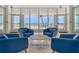 Bright lobby with multiple chairs, a round table, tile floors, and ocean views through large windows at 1750 Benjamin Franklin Dr # 6F, Sarasota, FL 34236