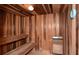 Inviting sauna room featuring wooden benches, wood-paneled walls and a modern heating unit at 1750 Benjamin Franklin Dr # 6F, Sarasota, FL 34236