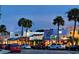 Stroll along the street with shops and eateries, lit by streetlights and palm trees, at night at 1750 Benjamin Franklin Dr # 6F, Sarasota, FL 34236