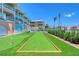 Backyard with lawn, palm trees, and bocce ball court at 1800 Gulf N Dr # 112, Bradenton Beach, FL 34217