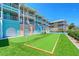 Exterior shot of building with lawn, bocce ball, and putting green at 1800 Gulf N Dr # 112, Bradenton Beach, FL 34217
