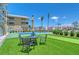 Backyard with seating area, manicured lawn, and a tennis court at 1800 Gulf N Dr # 112, Bradenton Beach, FL 34217