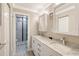 Modern bathroom with double sinks, marble countertops, and a glass-enclosed shower at 1800 Gulf N Dr # 112, Bradenton Beach, FL 34217
