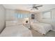 Bright bedroom with two twin beds, shutters on the windows, and coastal decor at 1800 Gulf N Dr # 112, Bradenton Beach, FL 34217