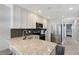 Modern kitchen with granite countertops, stainless steel appliances, and white cabinetry at 1800 Gulf N Dr # 112, Bradenton Beach, FL 34217