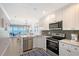 Updated kitchen with stainless steel appliances, granite countertops, and gorgeous ocean views at 1800 Gulf N Dr # 112, Bradenton Beach, FL 34217