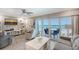 Inviting living room with ocean views, comfortable seating, and access to the balcony at 1800 Gulf N Dr # 112, Bradenton Beach, FL 34217