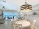 Bright and airy living room with dining area, a ceiling fan, and sliding glass doors to a balcony at 1800 Gulf N Dr # 112, Bradenton Beach, FL 34217