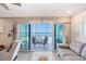Comfortable living room with a serene ocean view and balcony access at 1800 Gulf N Dr # 112, Bradenton Beach, FL 34217