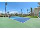 Enjoy a game on the community pickleball court with beautiful landscaping and sunny skies at 1800 Gulf N Dr # 112, Bradenton Beach, FL 34217