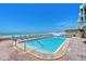Relax by the community pool with views of the ocean and plenty of lounge chairs at 1800 Gulf N Dr # 112, Bradenton Beach, FL 34217