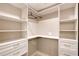 Organized walk-in closet with shelving, drawers, and hanging rods at 1800 Gulf N Dr # 112, Bradenton Beach, FL 34217