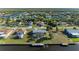 Aerial view of a home with a screened lanai, a boat dock and canal access at 18082 Eau Gallie S Cir, Port Charlotte, FL 33948