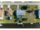 Aerial view of a screened-in pool home featuring a private boat dock and canal access at 18082 Eau Gallie S Cir, Port Charlotte, FL 33948