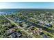 Aerial view of the neighborhood featuring waterfront homes along a canal with easy water access at 18082 Eau Gallie S Cir, Port Charlotte, FL 33948
