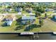 Aerial view of a waterfront home with a screened lanai, a private boat dock, and canal access at 18082 Eau Gallie S Cir, Port Charlotte, FL 33948