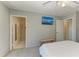 Bright en-suite bathroom with tile shower, light walls and a television at 18082 Eau Gallie S Cir, Port Charlotte, FL 33948