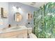 Bathroom featuring bright blue walls, a round mirror, and a leafy shower curtain at 18082 Eau Gallie S Cir, Port Charlotte, FL 33948