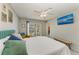 Bedroom with a teal upholstered headboard, white bedding and a large screen tv at 18082 Eau Gallie S Cir, Port Charlotte, FL 33948