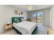 Bright bedroom featuring a plush green bed frame, light walls, and sliding glass doors to the outside at 18082 Eau Gallie S Cir, Port Charlotte, FL 33948
