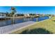 Waterfront home featuring a private boat dock, canal access and lush tropical landscaping at 18082 Eau Gallie S Cir, Port Charlotte, FL 33948