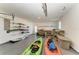Spacious garage with shelving for storage and room for kayaks and a work area at 18082 Eau Gallie S Cir, Port Charlotte, FL 33948